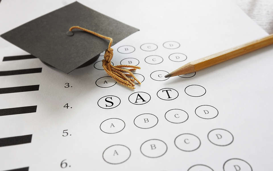 Detail of standardized test form with academic cap, symbolizing SAT preparation by The Red Pen
