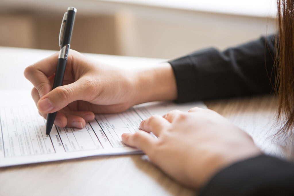 Focused application preparation for US colleges shown by student paperwork - The Red Pen