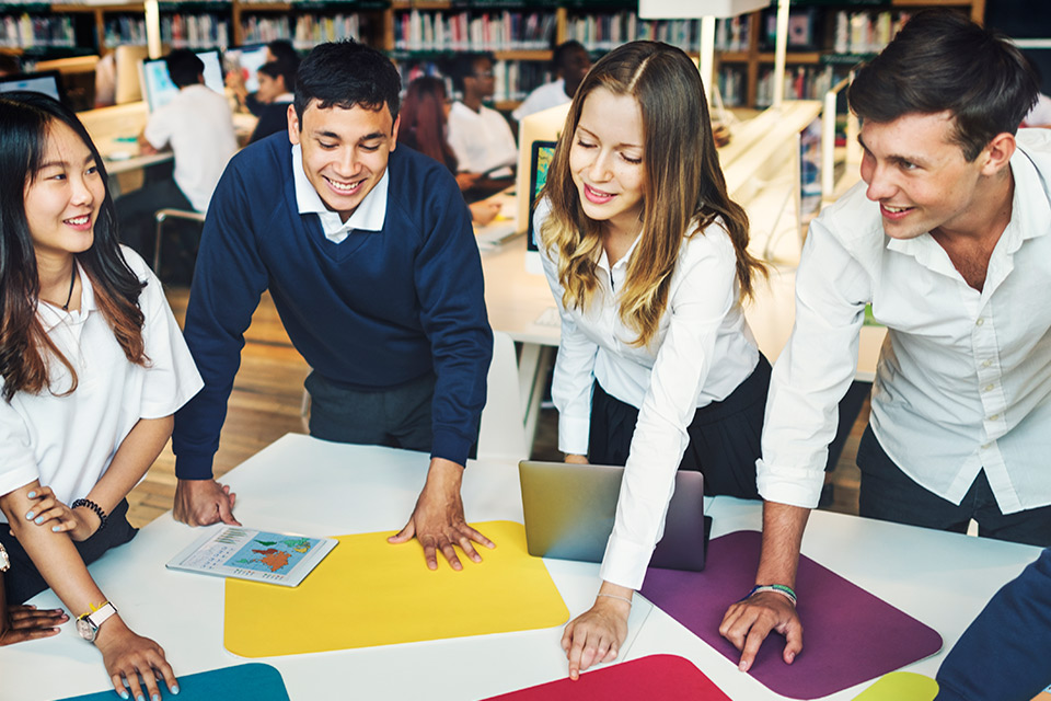 International students engaged in group study at a boarding school library - The Red Pen