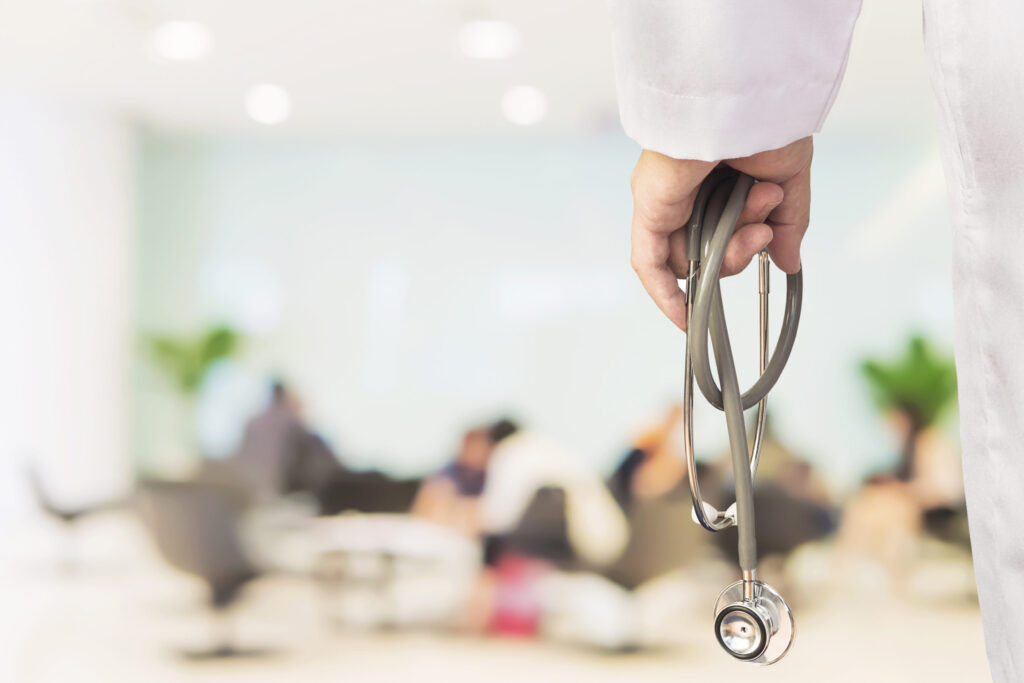 Doctor holding stethoscope in a modern hospital setting, symbolizing global medical education, by The Red Pen