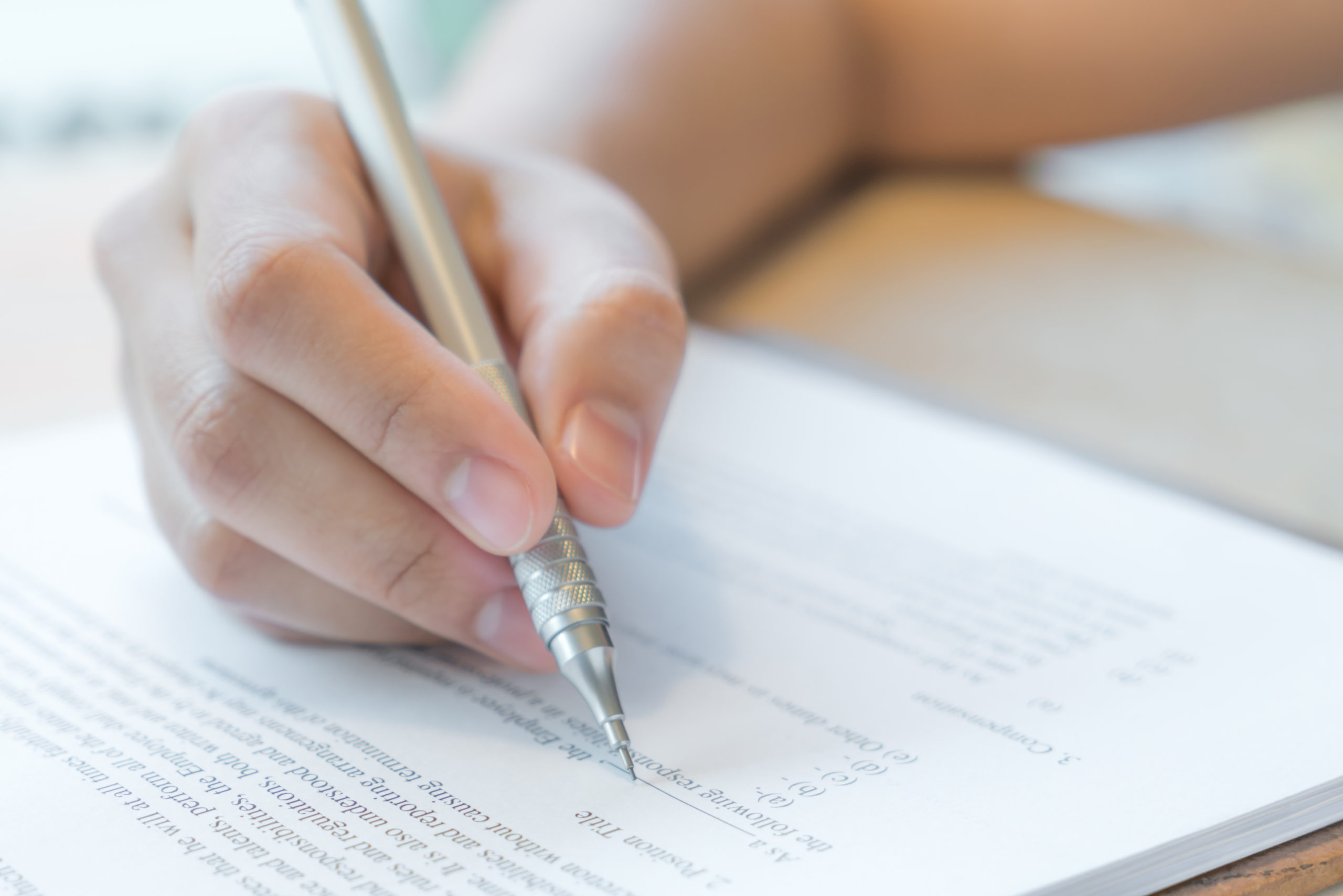 Close-up of student preparing college paperwork without SAT requirement for 2021 admissions – The Red Pen