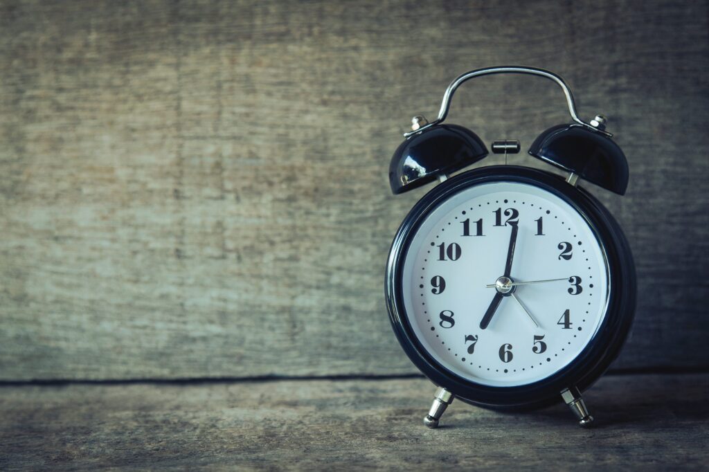 Close-up of vintage clock representing importance of tracking MBA application dates – The Red Pen
