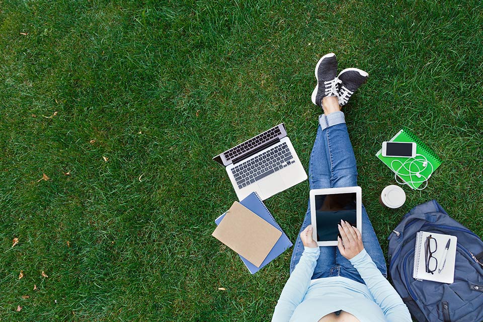 Writing a UCAS personal statement on a laptop and tablet outdoors – The Red Pen