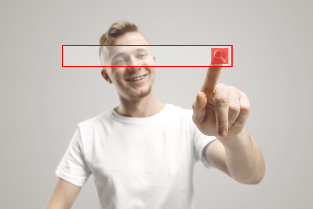 Student selecting a university through a digital search bar, symbolizing the UCAS shortlisting process - The Red Pen
