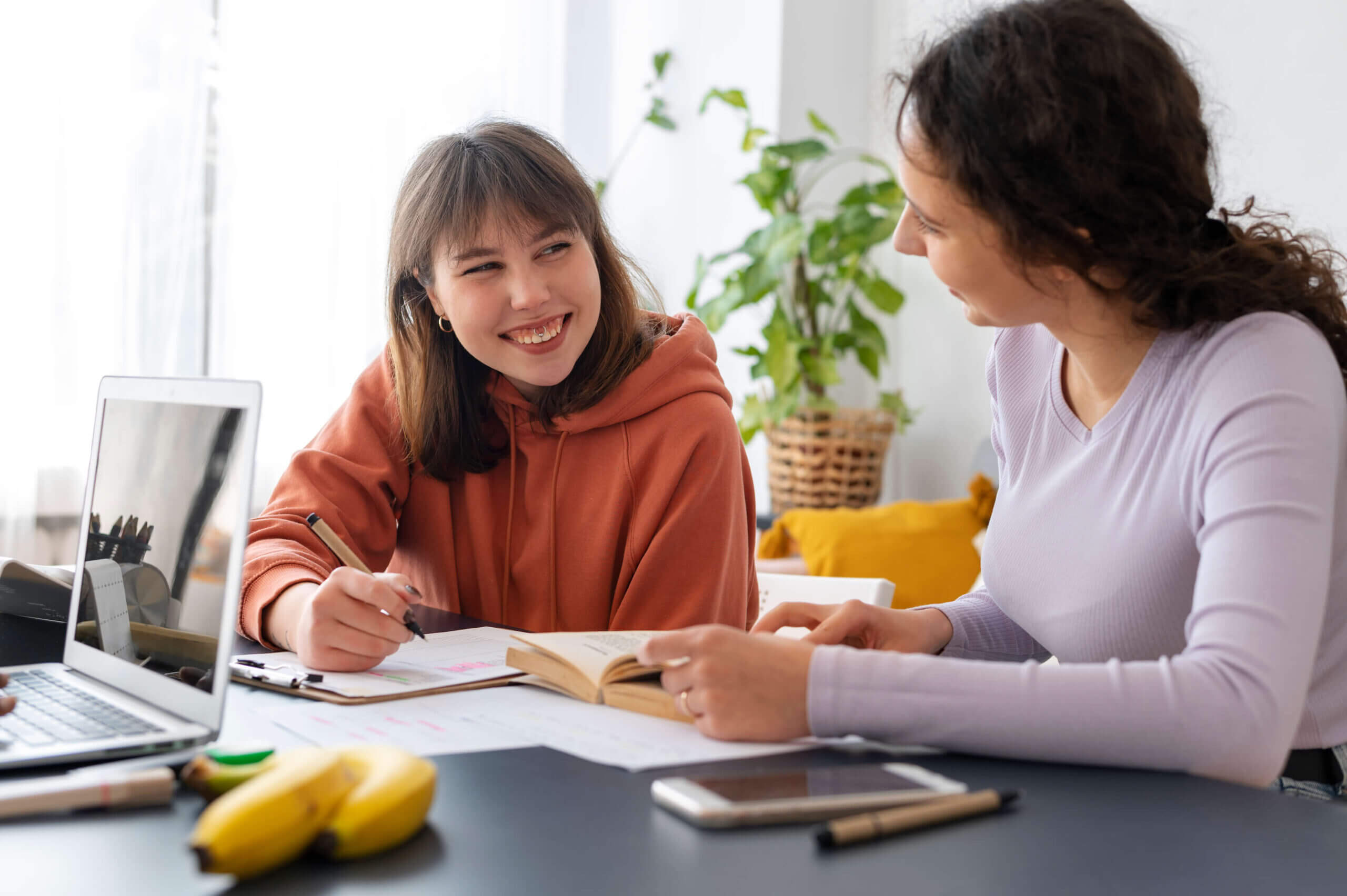 Friendly study session with admissions consulting materials on the table - The Red Pen