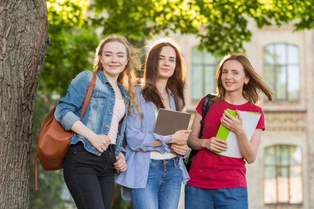Group of young students in front of school building